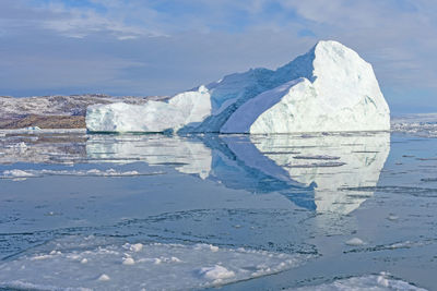 Bright reflections on arctic waters near eqip sermia in greenland