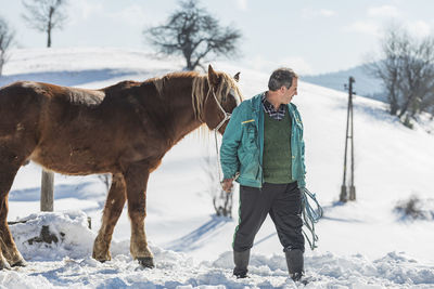 Full length of a horse on snow covered field