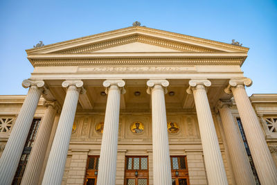 Low angle view of historical building against clear blue sky