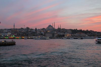 View of city at waterfront during sunset