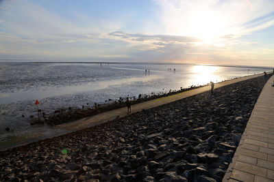 Scenic view of beach against sky during sunset