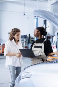 Side view of business colleagues using digital tablet