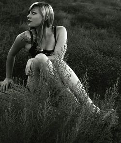 Portrait of young woman sitting on field