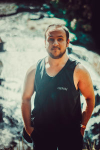 Portrait of young man standing outdoors