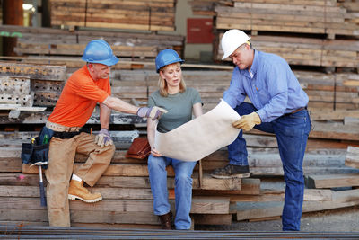 Group of construction workers looking over plans