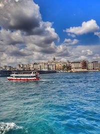 Scenic view of sea by buildings against sky