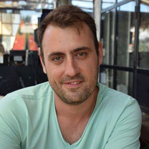 Portrait of smiling mid adult man at sidewalk cafe