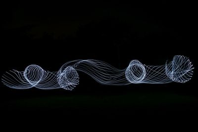 Illuminated light painting against black background