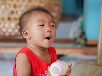 Cute boy having milk at home