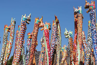 Low angle view of colorful dragon artwork against clear sky