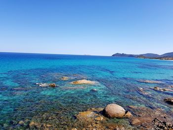 Scenic view of sea against clear blue sky