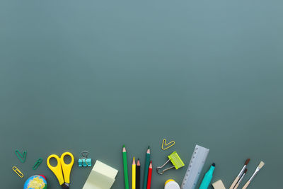 Close-up of multi colored pencils against blue background