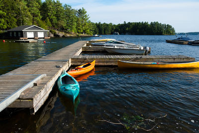 Boat moored on lake against sky