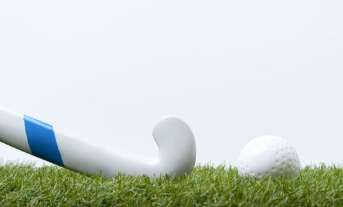 Close-up of ball on field against clear sky