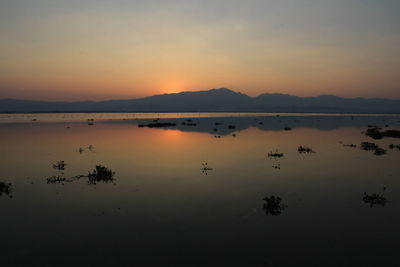 Scenic view of lake against sky during sunset