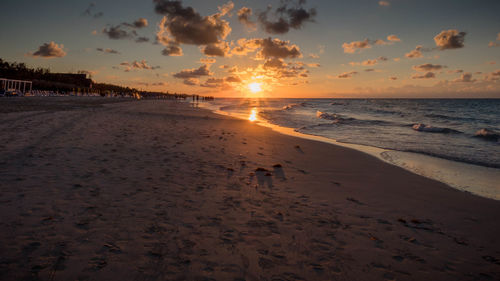 Scenic view of beach against sky during sunset