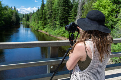 Rear view of woman in lake against trees