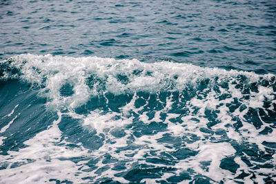 High angle view of waves splashing on sea