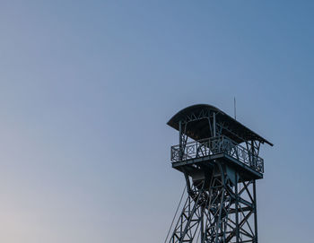 Low angle view of communications tower against clear sky