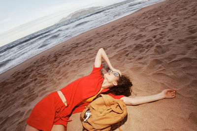 High angle view of woman sitting at beach