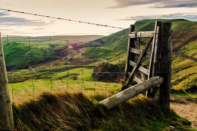 Fence on field against sky
