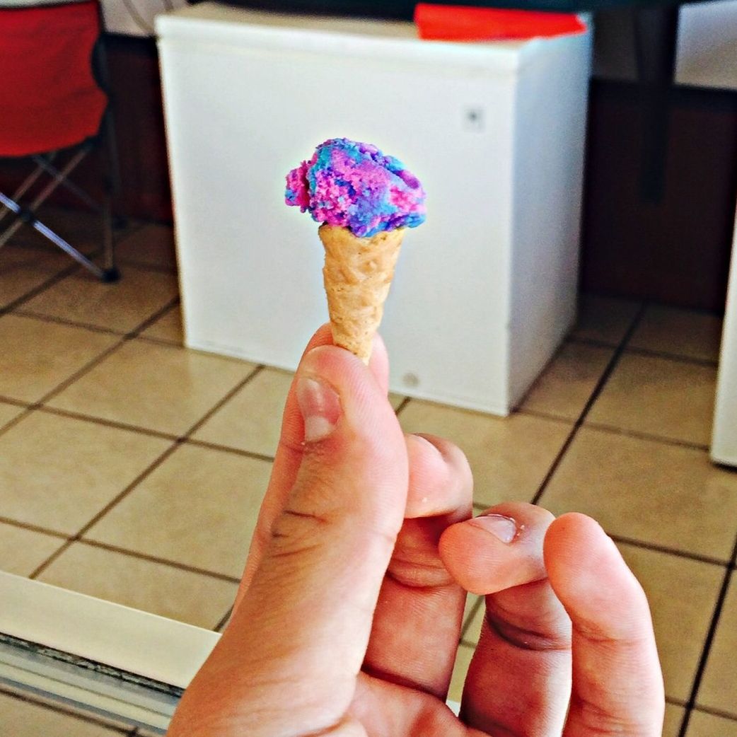 person, holding, part of, cropped, human finger, indoors, lifestyles, personal perspective, unrecognizable person, leisure activity, focus on foreground, close-up, pink color, nail polish, day, sweet food