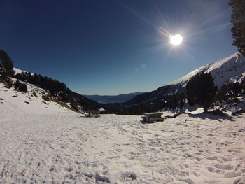 Scenic view of landscape against clear sky during winter