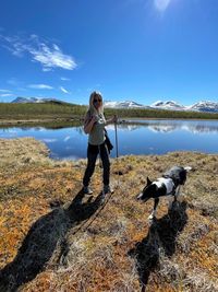 Woman with dog standing in lake