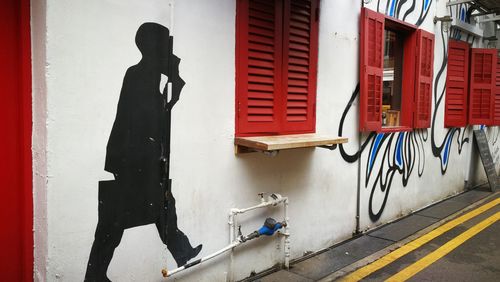 Man walking on red door