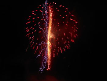 Low angle view of firework display at night