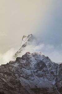 Low angle view of snowcapped mountain against sky