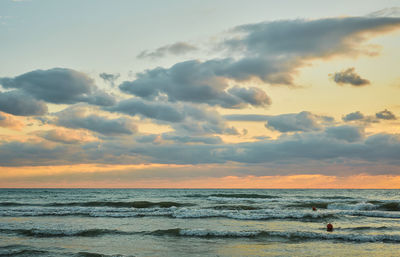 Sunset over the sea with colorful clouds, orange sunlight, autumn sunsets, early autumn