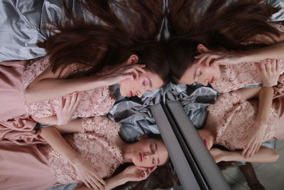 High angle view of girl lying down by mirror