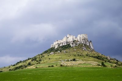 Scenic view of mountains against cloudy sky