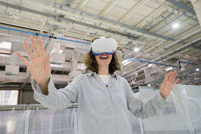 Excited woman exploring virtual reality in goggles