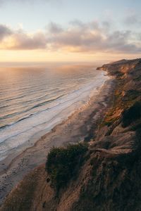 Scenic view of beach against sky during sunset