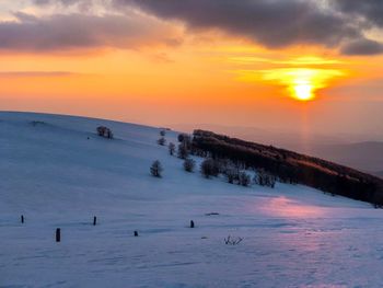 Scenic view of snow covered sky during sunset