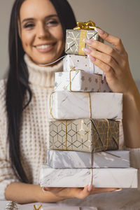 Portrait of woman holding gift box