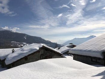 Snow covered landscape against sky