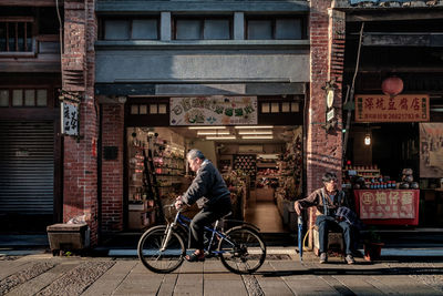 Bicycles on street against building in city