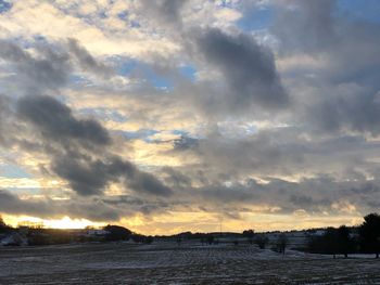 Scenic view of frozen lake against sky during sunset