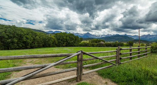 Scenic view of agricultural field against storm clouds