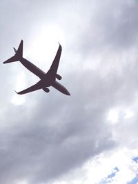 Low angle view of airplane flying in sky