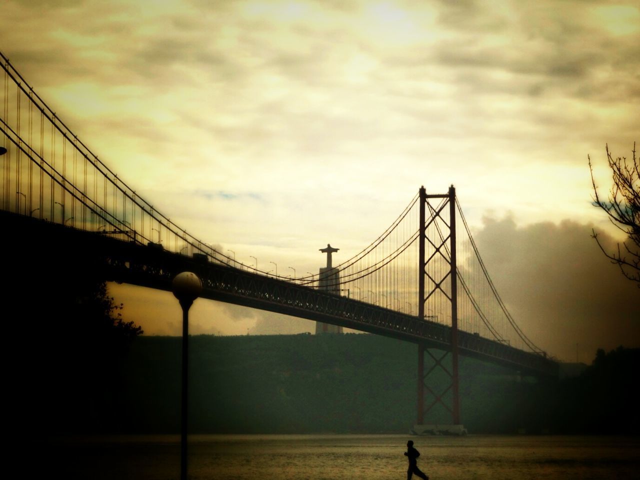 connection, bridge - man made structure, sky, engineering, built structure, architecture, sunset, suspension bridge, silhouette, bridge, cloud - sky, transportation, low angle view, river, cloudy, cloud, travel destinations, cable-stayed bridge, dusk, water