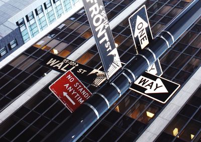 Low angle view of sign board against sky