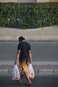 Rear view of couple walking in city
