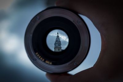 Close-up of hand photographing camera