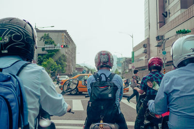 Rear view of people on street in city