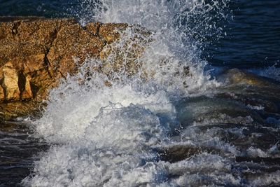 Sea waves splashing on rocks