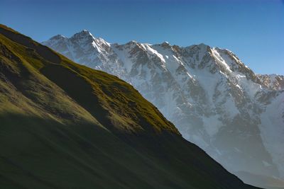 Scenic view of snowcapped mountains against clear sky